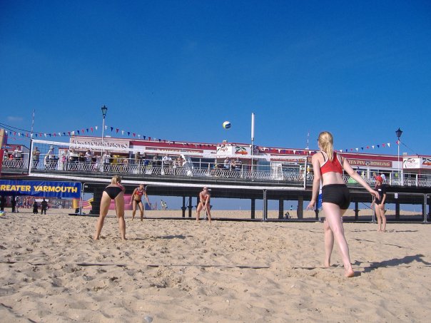 Girls playing in front of the pier